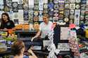 Michelle Rutkowski, owner of Boardwalk Best and Five Mile Marketplace, hands a customer a receipt i…