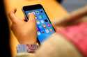 A child holds an iPhone at an Apple store on Sept