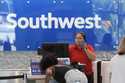 A Southwest Airlines ticket agent checks in passengers at Love Field in Dallas, July 25, 2024