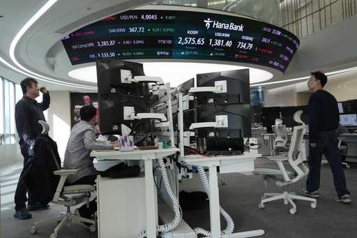 Currency traders work at the foreign exchange dealing room of the KEB Hana Bank headquarters in Seo…