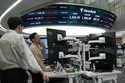 Currency traders work at the foreign exchange dealing room of the KEB Hana Bank headquarters in Seo…