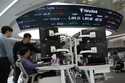 Currency traders watch monitors at the foreign exchange dealing room of the KEB Hana Bank headquart…