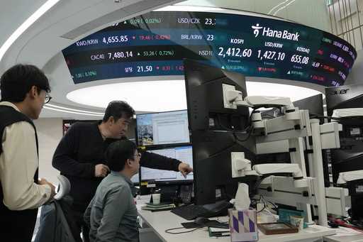 Currency traders work at the foreign exchange dealing room of the KEB Hana Bank headquarters in Seo…