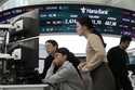 Currency traders watch monitors at the foreign exchange dealing room of the KEB Hana Bank headquart…