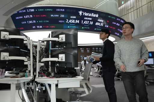 Currency traders work at the foreign exchange dealing room of the KEB Hana Bank headquarters in Seo…