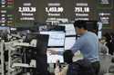 Currency traders watch monitors at the foreign exchange dealing room of the KEB Hana Bank headquart…