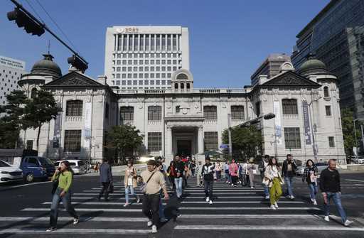 People pass by the headquarters of the Bank of Korea in Seoul, South Korea, October 16, 2019