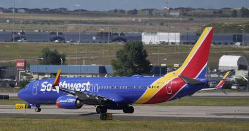 A Southwest Airlines jetliner waits on a runway for departure from Denver International Airport Fri…