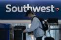 A traveler walks through the Southwest Airlines ticketing counter area at the Los Angeles Internati…