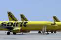 A line of Spirit Airlines jets sit on the tarmac at Orlando International Airport on May 20, 2020, …