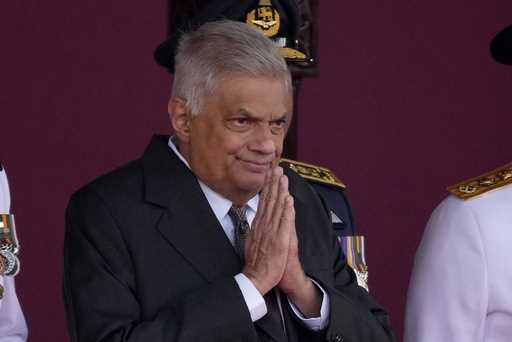 Sri Lankan President Ranil Wickremesinghe greets a group of school children who welcomed him with a…