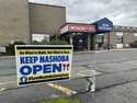 A sign pushing to keep the hospital open stands outside Nashoba Valley Medical Center in Ayer, Mass…