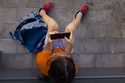 A 11-year-old boy plays with his father's phone outside school in Barcelona, Spain, Monday, June 17…