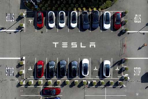 Tesla vehicles line a parking lot at the company's Fremont, Calif