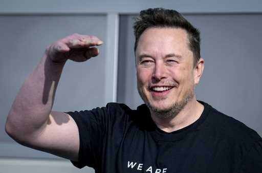 Tesla CEO Elon Musk waves as he leaves the Tesla Gigafactory for electric cars in Gruenheide near B…