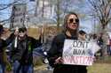 Abby Wigger protests against Elon Musk and President Donald Trump outside a Tesla dealership Saturd…