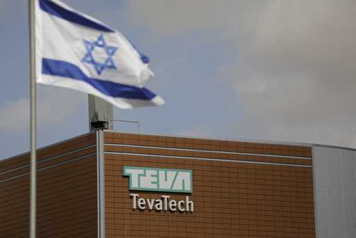 Israeli flag flies outside Teva Pharmaceutical facility building in Neot Hovav, Israel, on December…