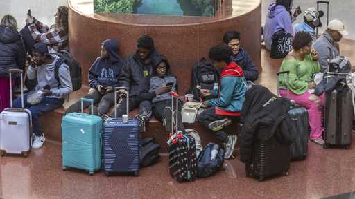 Travelers wait at Hartsfield-Jackson International Airport, Friday, November 22, 2024, in Atlanta, …