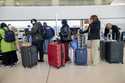 Travelers line up to check in their bags into San Francisco International Airport on Wednesday, Nov…