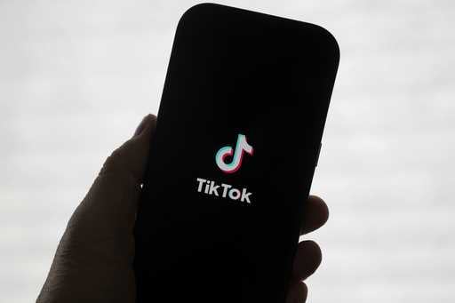 A TikTok logo is shown on a phone in San Francisco, Friday, January 17, 2025. (AP Photo/Jeff Chiu)