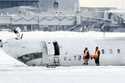 A Delta Air Lines plane lies upside down at Toronto Pearson Airport on Tuesday, February 18, 2025