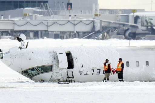 A Delta Air Lines plane lies upside down at Toronto Pearson Airport on Tuesday, February 18, 2025