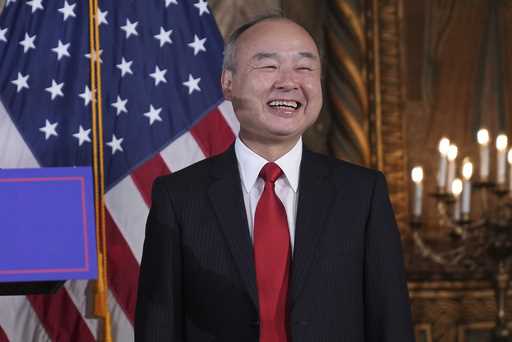 SoftBank Group CEO Masayoshi Son smiles as he listens to President-elect Donald Trump during a news…