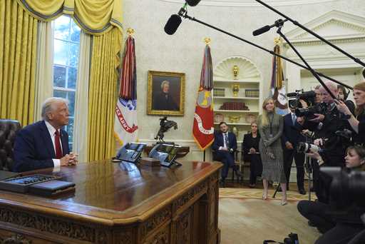 President Donald Trump talks with reporters as he signs executive orders in the Oval Office at the …