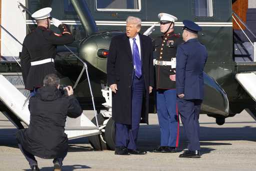 President Donald Trump, center, arrives on Marine One to board Air Force One at Joint Base Andrews,…