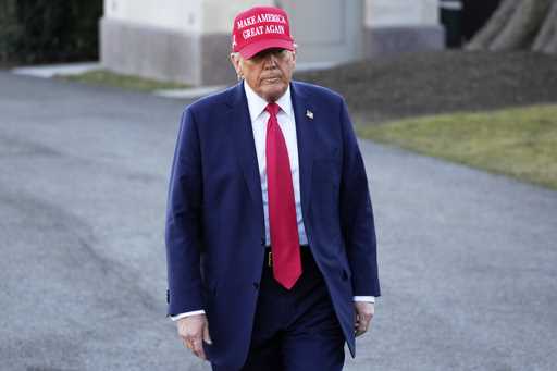 President Donald Trump walks before talking with reporters before boarding Marine One on the South …