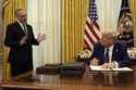 President Donald Trump listens to White House adviser David Sacks as he signs an executive order re…