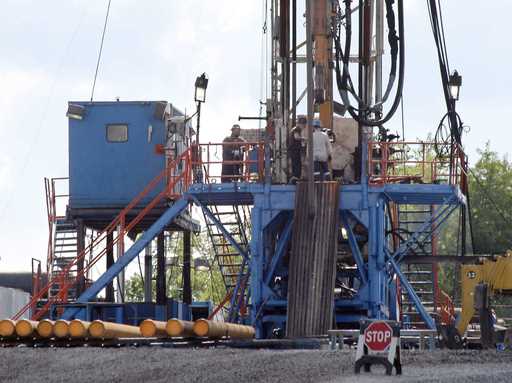 A crew works on a gas drilling rig at a well site for shale based natural gas in Zelienople, Pa