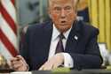 President Donald Trump talks as he signs executive orders in the Oval Office of the White House, Mo…