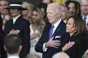 Former President Joe Biden and former Vice President Kamala Harris stand as Christopher Macchio per…