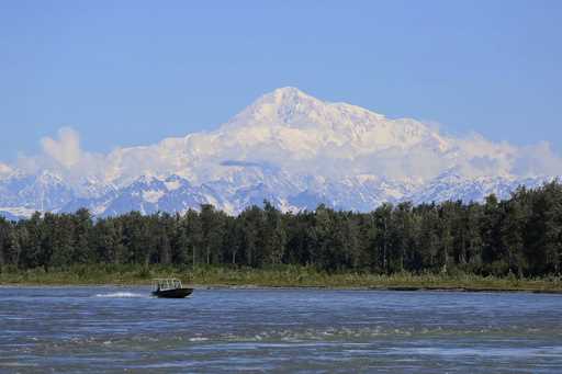 A boat is seen on the Susitna River near Talkeetna, Alaska, on Sunday, June 13, 2021, with Denali i…