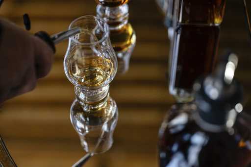 An employee pours a glass of The Bard's product in what will be a new production area at The Bard D…