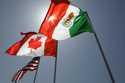 National flags representing the United States, Canada, and Mexico fly in the breeze in New Orleans …