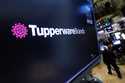 The logo for Tupperware Brands appears above a trading post on the floor of the New York Stock Exch…