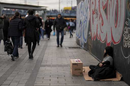 Young girls sell tissues to passersby on the Karakoy sea promenade in Istanbul, Turkey, Saturday, D…