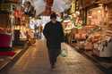 A man carries a bag with groceries in a food street market at Uskudar neighbourhood in Istanbul, Tu…