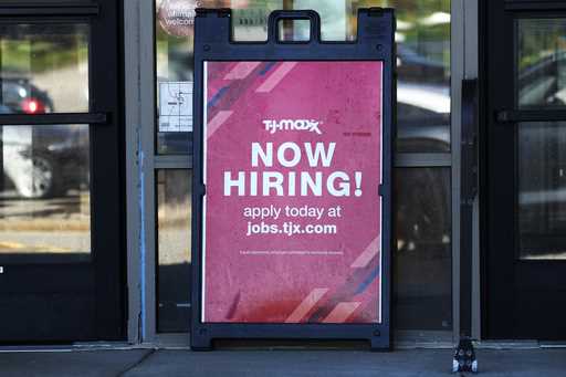 A hiring sign is displayed at a retail store in Vernon Hills, Ill