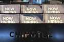 Hiring signs are displayed at a restaurant in Buffalo Grove, Ill