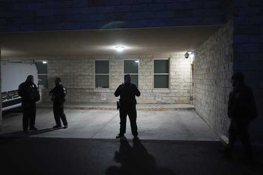 Police officers wait for the arrival of Luigi Nicholas Mangione at Blair County Courthouse in Holli…