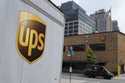 A delivery vehicle passes by a UPS depot, June 29, 2023, in New York