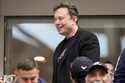 Elon Musk talks to other spectators while watching play between Jannik Sinner, of Italy, and Taylor…