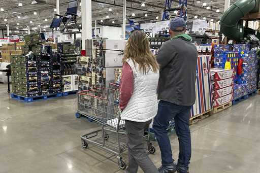 Shoppers pass displays of goods in a Costco warehouse Sunday, February 25, 2024, in Sheridan, Colo