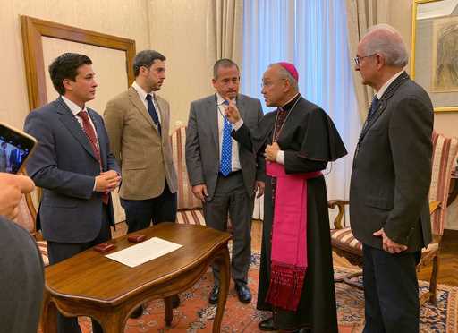 Then-Deputy Vatican secretary of state Monsignor Edgar Peña Parra, second from right, receives a Ve…