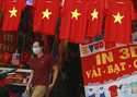 A man walks past a row of T-shirts printed with Vietnamese flags in Hanoi, Vietnam on July 30, 2020…