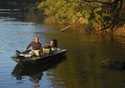 Farmer and land owner Glenn Cox maneuvers his boat along the banks of the Flint River near Newton, …