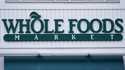 The Whole Foods Market logo is shown on the front of a store, July 14, 2021, in Cambridge, Mass